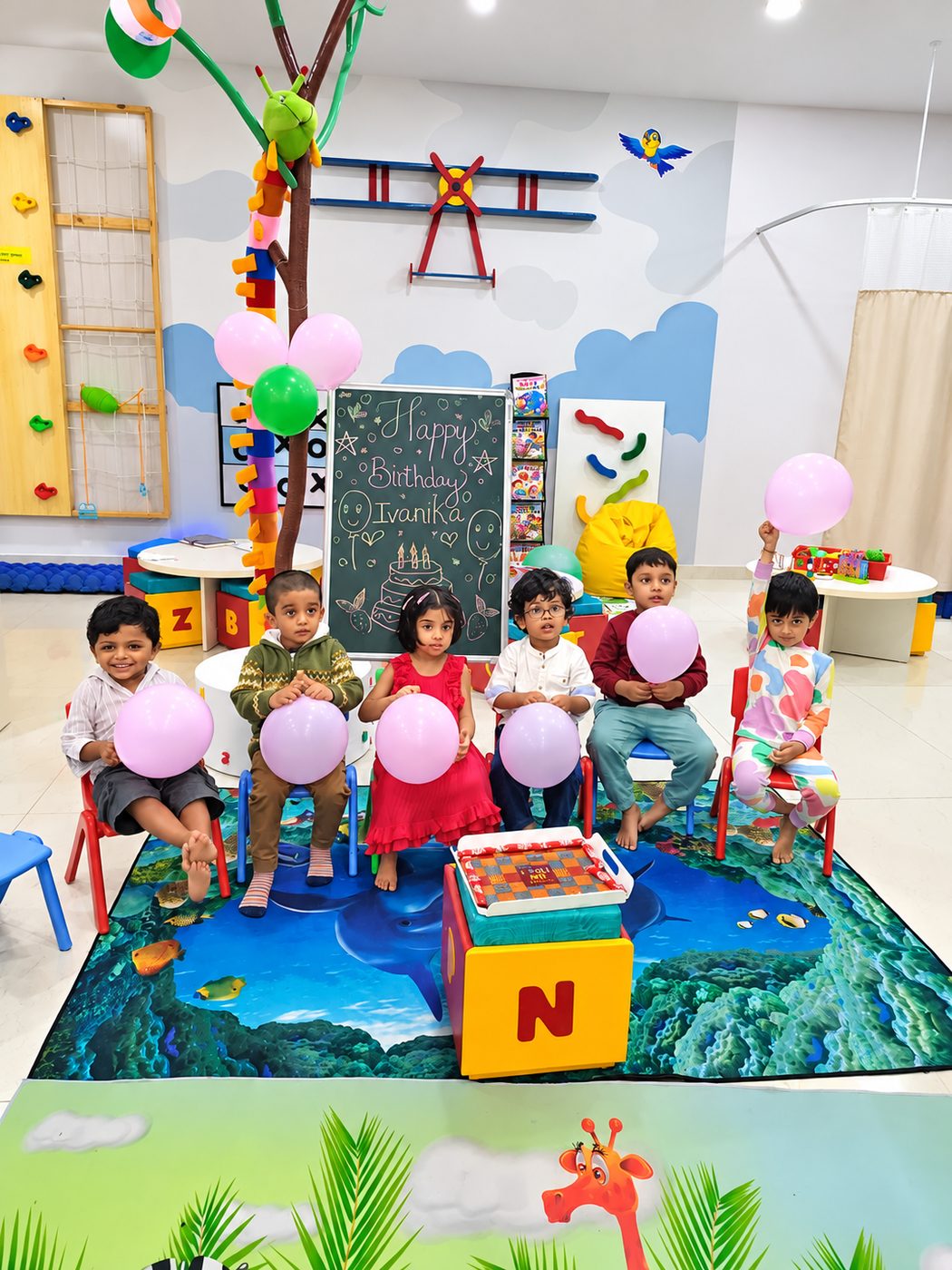 Children celebrating a birthday with balloons at Doon Kids